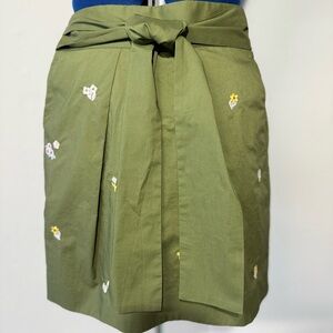 J Crew olive green skirt with embroidered flowers.  Tie front, zip back